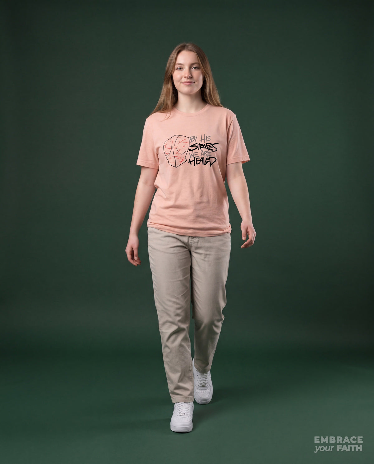 By His Stripes We Are Healed T-Shirt with black print in Heather Prism Peach, worn by a model