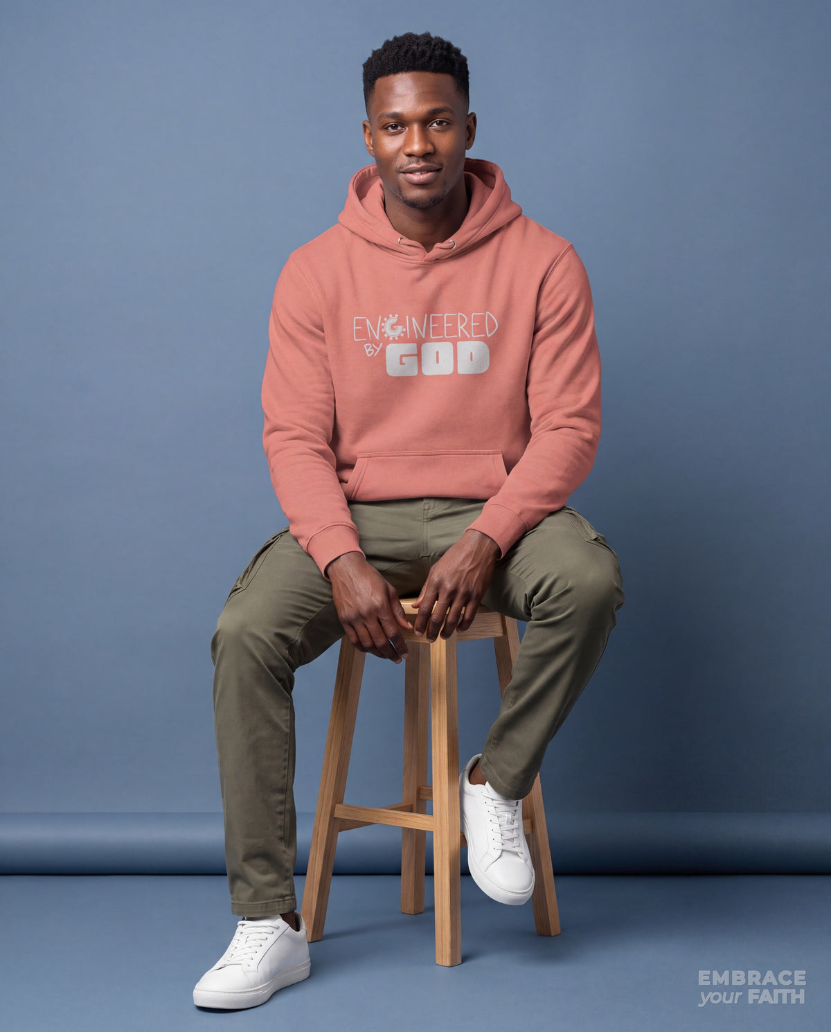EYF model wearing the Engineered By God Classic Unisex Hoodie in Dusty Rose
