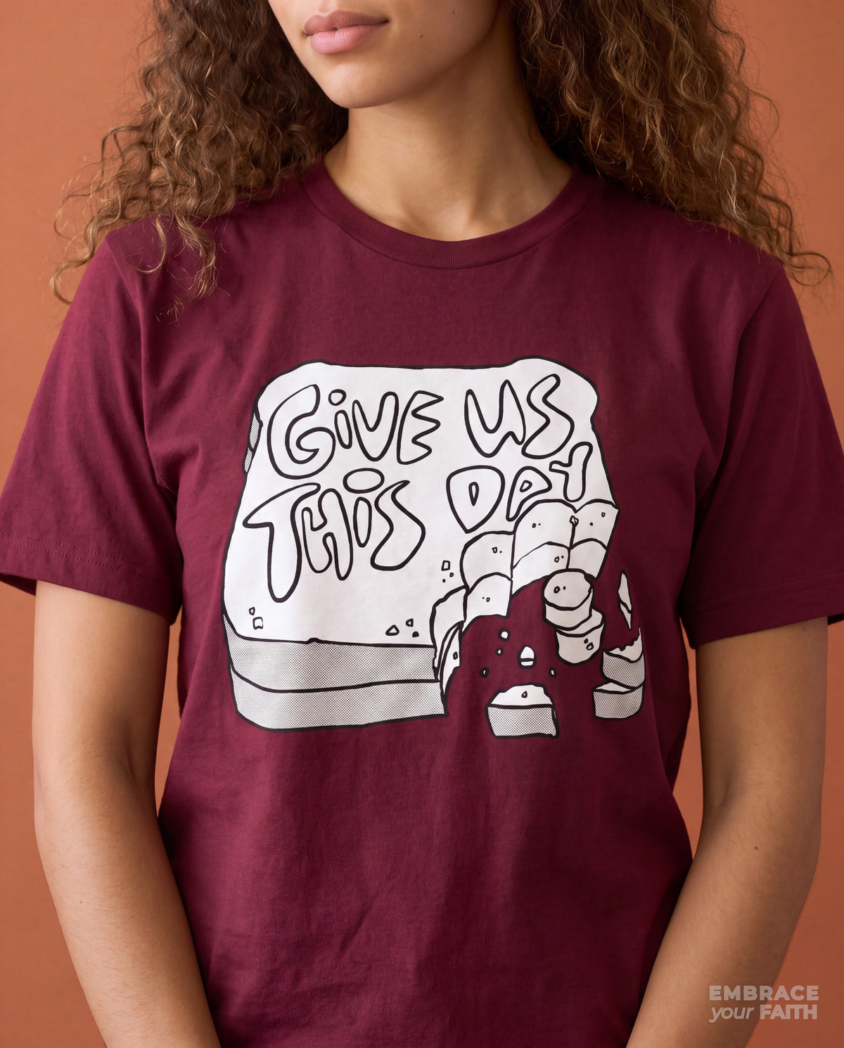 Close-up of the print on the Give Us This Day Classic Unisex T-Shirt in Maroon