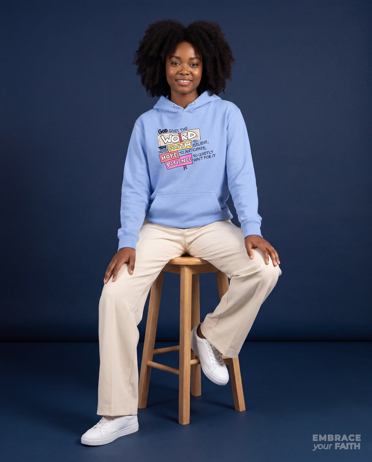 EYF model wearing the God Gives the Word Unisex Hoodie (Premium) in Carolina Blue