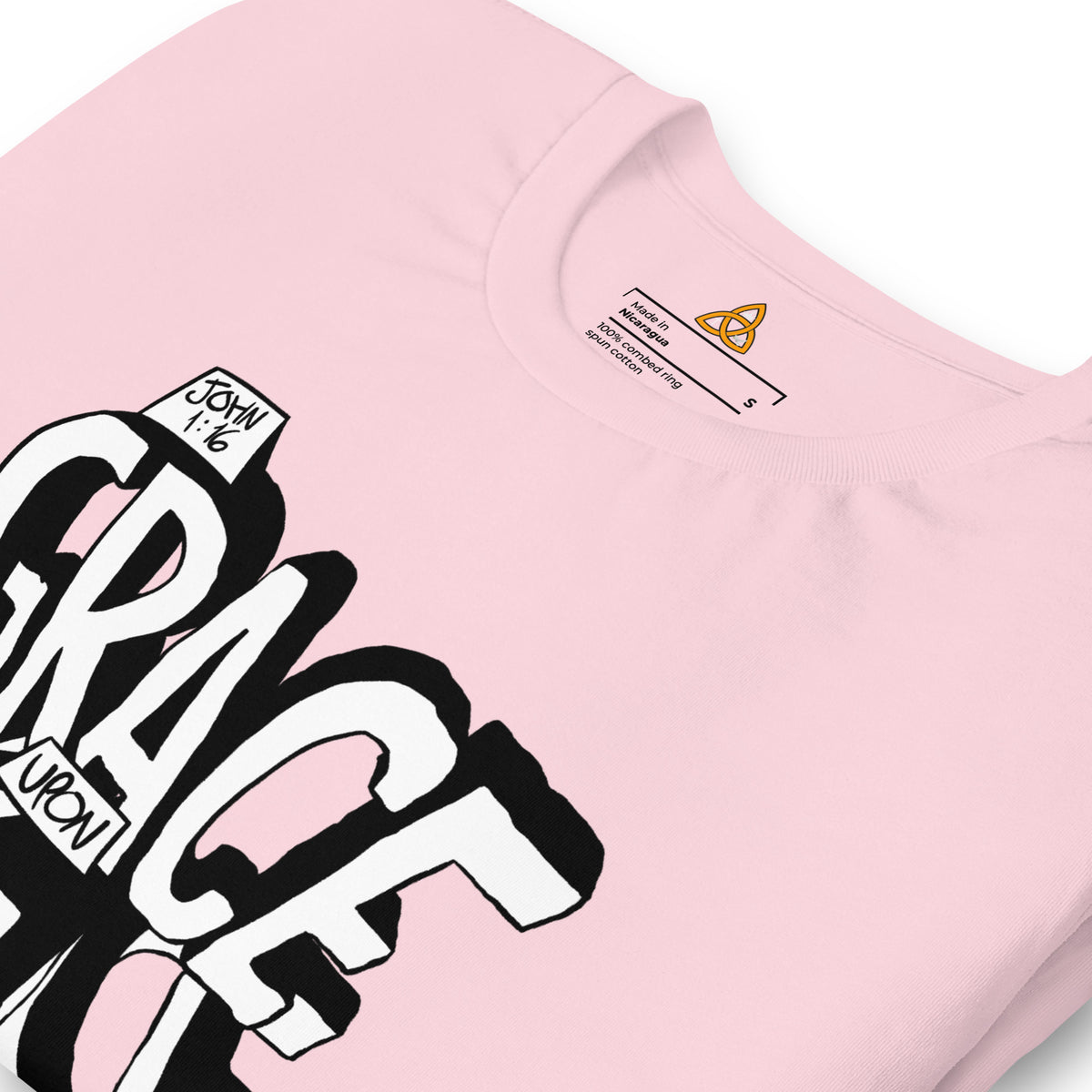 Close-up of the Grace Upon Grace T-Shirt print in Soft Pink – John 1:16