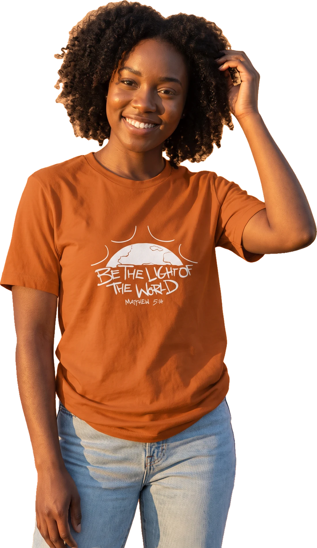 Smiling young woman wearing the Autumn orange Be The Light of The World tee